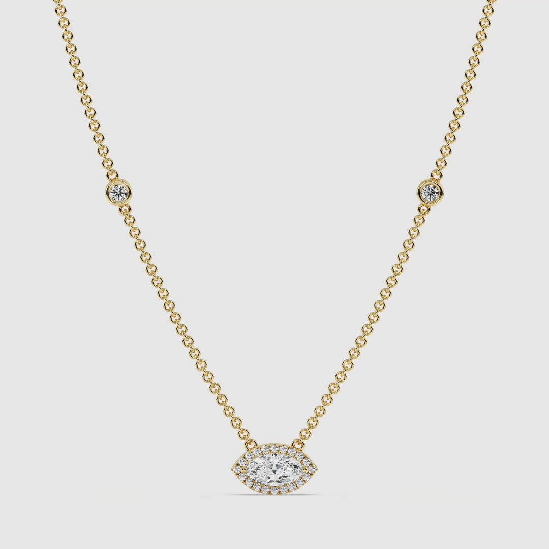 Video showcasing the Elegant Marquise Diamond Accent Bezel Station Necklace in 18K Yellow Gold. The necklace features a 1.00ct IGI Certified marquise-cut lab-grown diamond bezel-set at the center, surrounded by 20 sparkling round EF/VS lab-grown diamonds. The 18-inch yellow gold chain is adorned with 6 additional round lab-grown diamonds, highlighting its luxurious and timeless design from every angle.