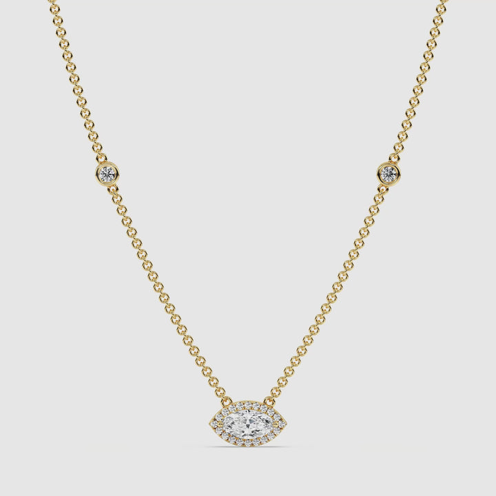 Video showcasing the Elegant Marquise Diamond Accent Bezel Station Necklace in 18K Yellow Gold. The necklace features a 1.00ct IGI Certified marquise-cut lab-grown diamond bezel-set at the center, surrounded by 20 sparkling round EF/VS lab-grown diamonds. The 18-inch yellow gold chain is adorned with 6 additional round lab-grown diamonds, highlighting its luxurious and timeless design from every angle.